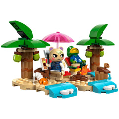 LEGO Animal Crossing set featuring Kapp’n and Marshall on a sandy beach with palm trees, an umbrella, and a campfire.
