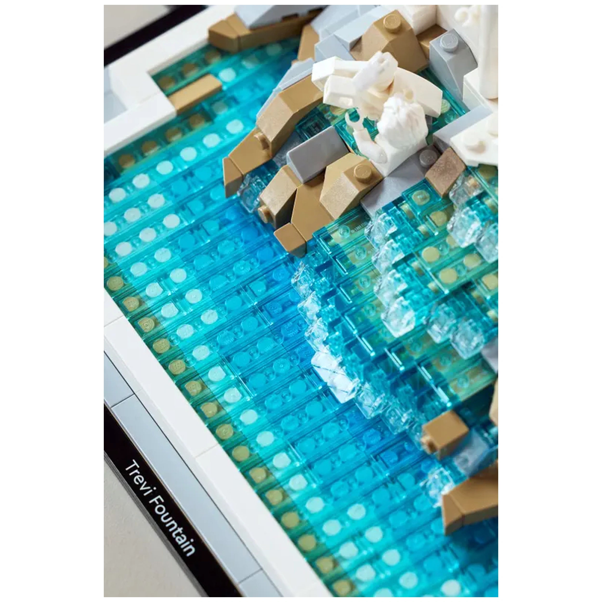 Detailed view of the LEGO® Architecture Trevi Fountain set, featuring a vibrant blue water area with clear and beige bricks mimicking the fountain's flow.
