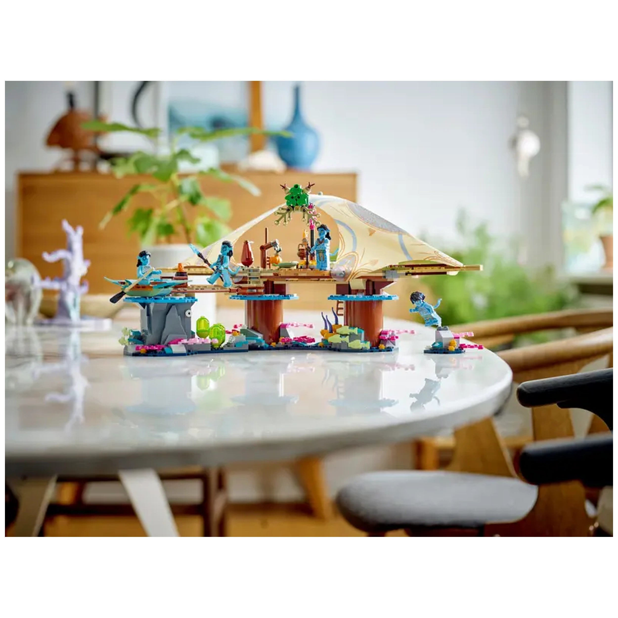 LEGO® Avatar Metkayina Reef Home construction set featuring a detailed dwelling atop wooden stilts, surrounded by colorful coral and vibrant character minifigures, including Neytiri and Kiri.