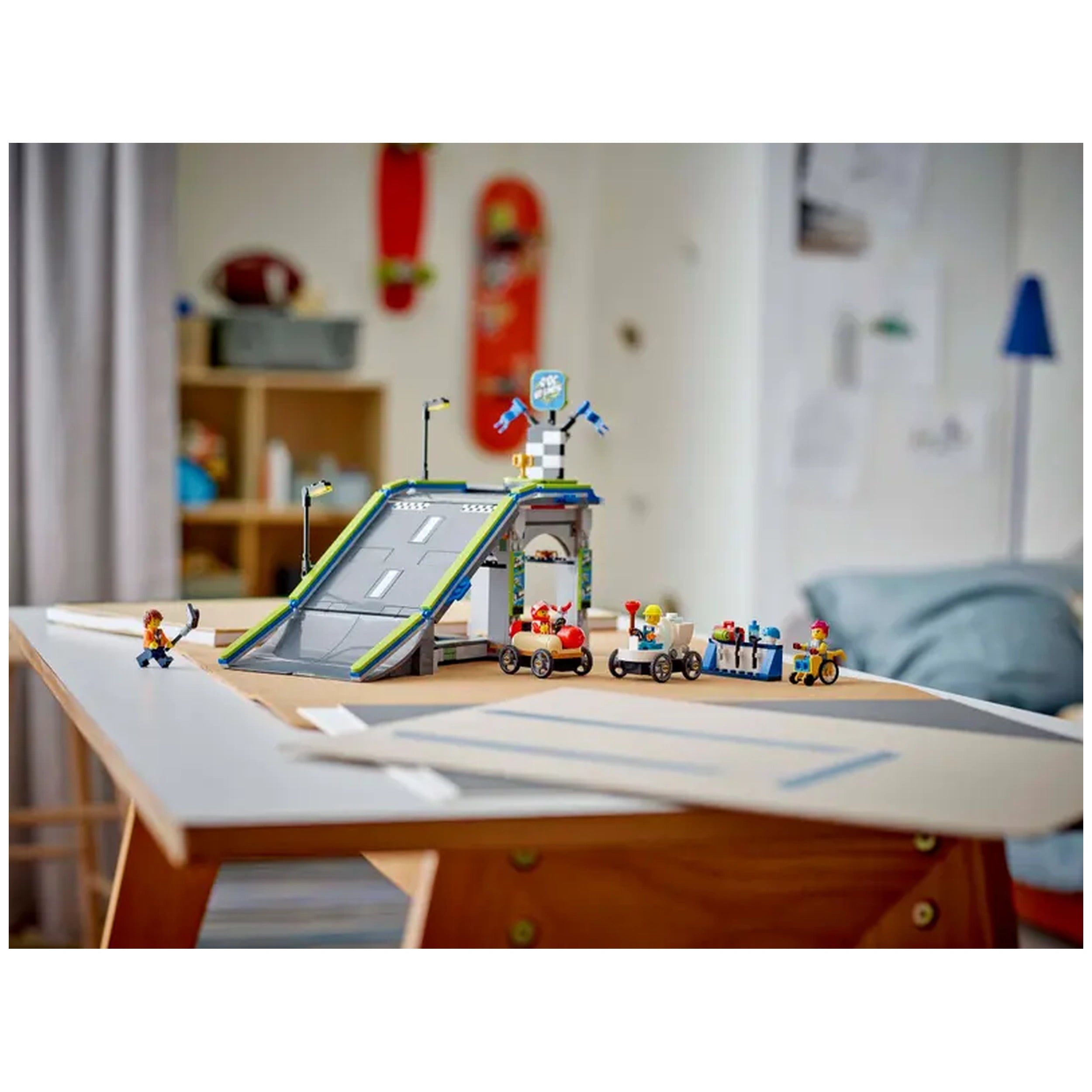 A colorful LEGO® City Race Car Ramp Track set featuring a tall gray ramp with checkered flags, two quirky soapbox vehicles, and a minifigure with a flag, staged on a wooden table in a playful room setting.