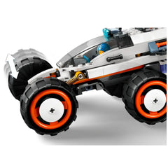 LEGO® City Space Explorer Rover in white and black, featuring oversized orange and black tires, a clear cockpit, and a blue minifigure inside.