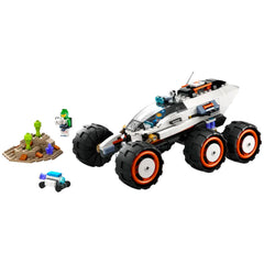 LEGO® City Space Explorer Rover with oversized tires, accompanied by two minifigures and an alien figure near a colorful alien terrain.