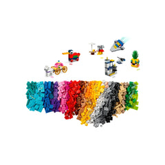 Colorful assortment of LEGO® bricks in various shades, featuring mini builds like a pirate ship, car, and a police station.