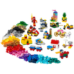 Colorful LEGO® bricks arranged in a spiral, featuring 15 mini builds like a pirate ship, elephant, and yellow castle, alongside vibrant piles of bricks in red, blue, green, and more.