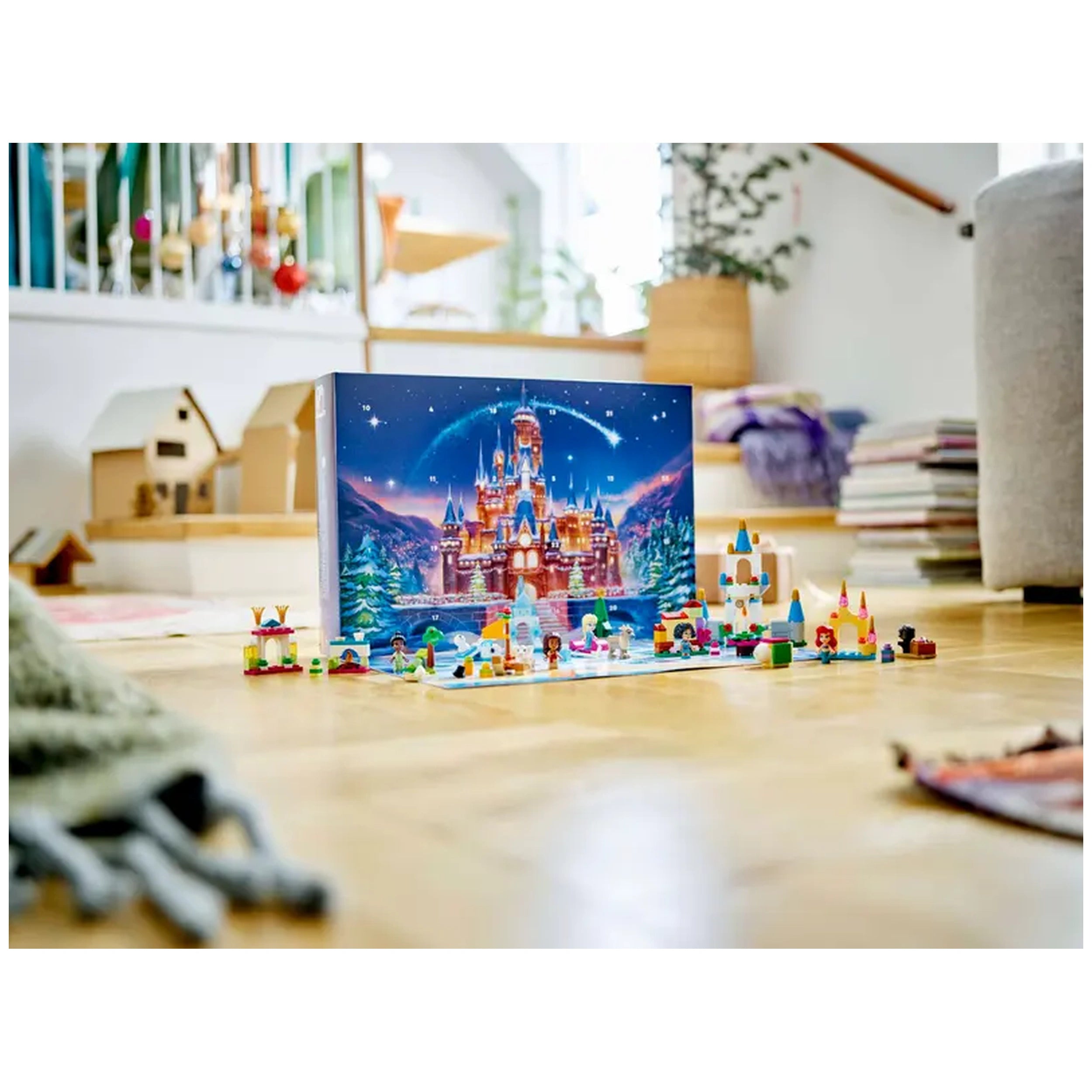 Colorful LEGO® Disney Advent Calendar set on a wooden floor, featuring a castle backdrop and various micro-doll figures, surrounded by playful builds, all under twinkling stars.