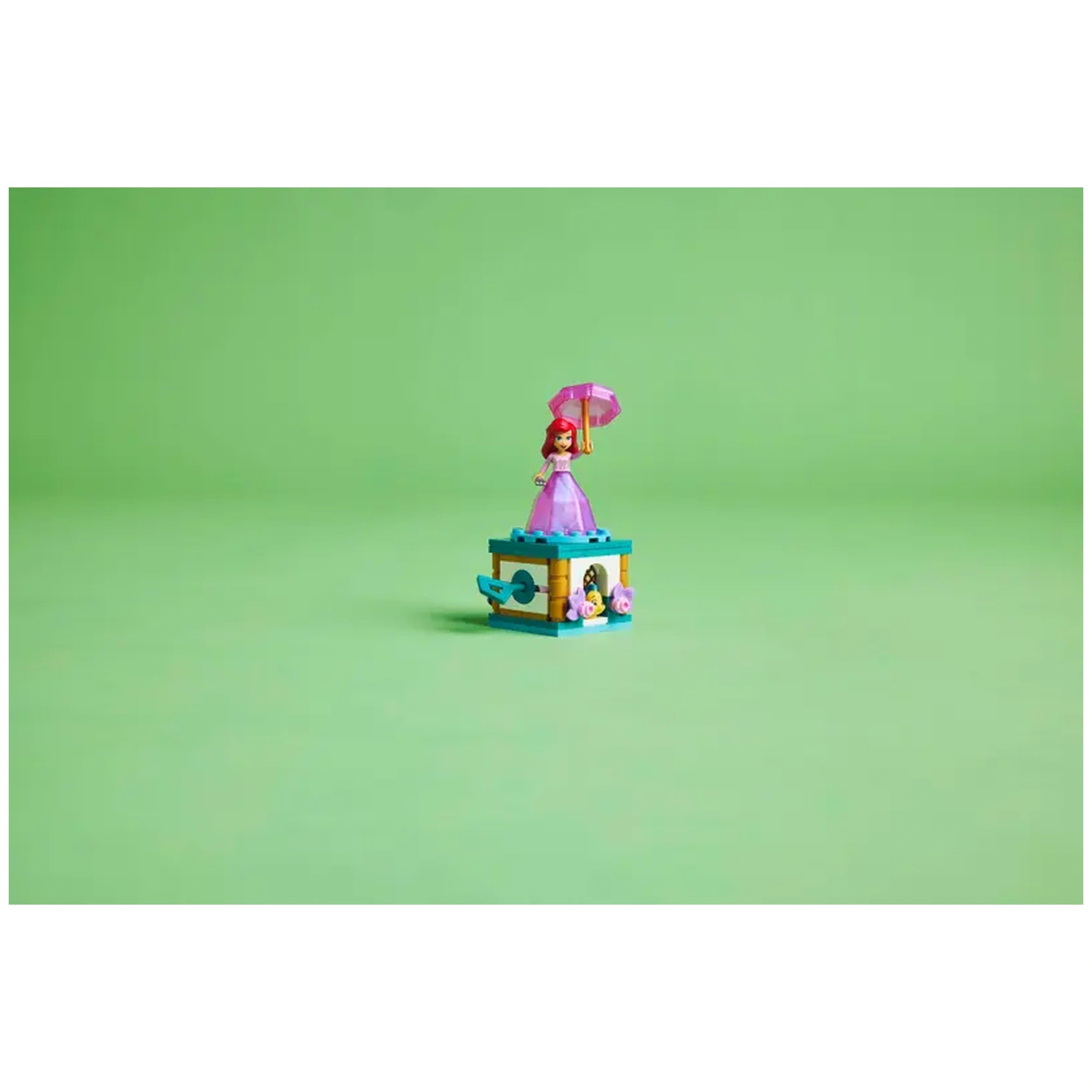 LEGO Disney Princess Twirling Ariel construction set featuring a mini Arieldoll in a pink dress holding a pink umbrella, atop a colorful base with flowers.
