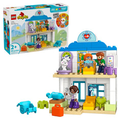 Colorful LEGO® DUPLO® hospital playset featuring a two-story structure, four characters, a medical cart, and various props for imaginative play.