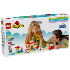 Child and adult engaging with LEGO® DUPLO® Peppa Pig Supermarket set, featuring colorful figures and a red car in a playful setting.