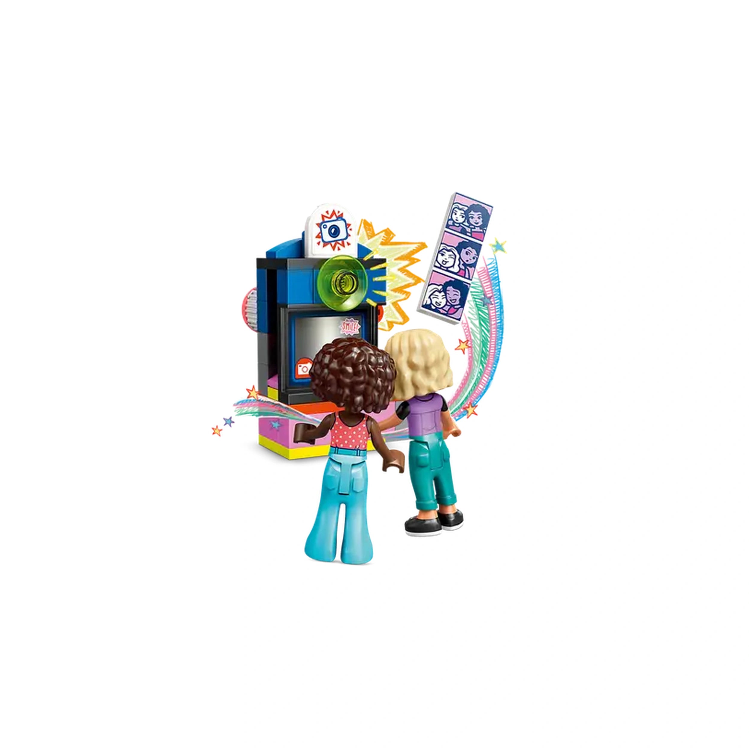 Two LEGO Friends mini-dolls, one with curly brown hair and the other with straight blonde hair, stand in front of a colorful photo booth. The booth features vibrant decorations, a green light, and photo strips displayed beside it. They are both engaged in playful anticipation, ready to capture fun moments.
