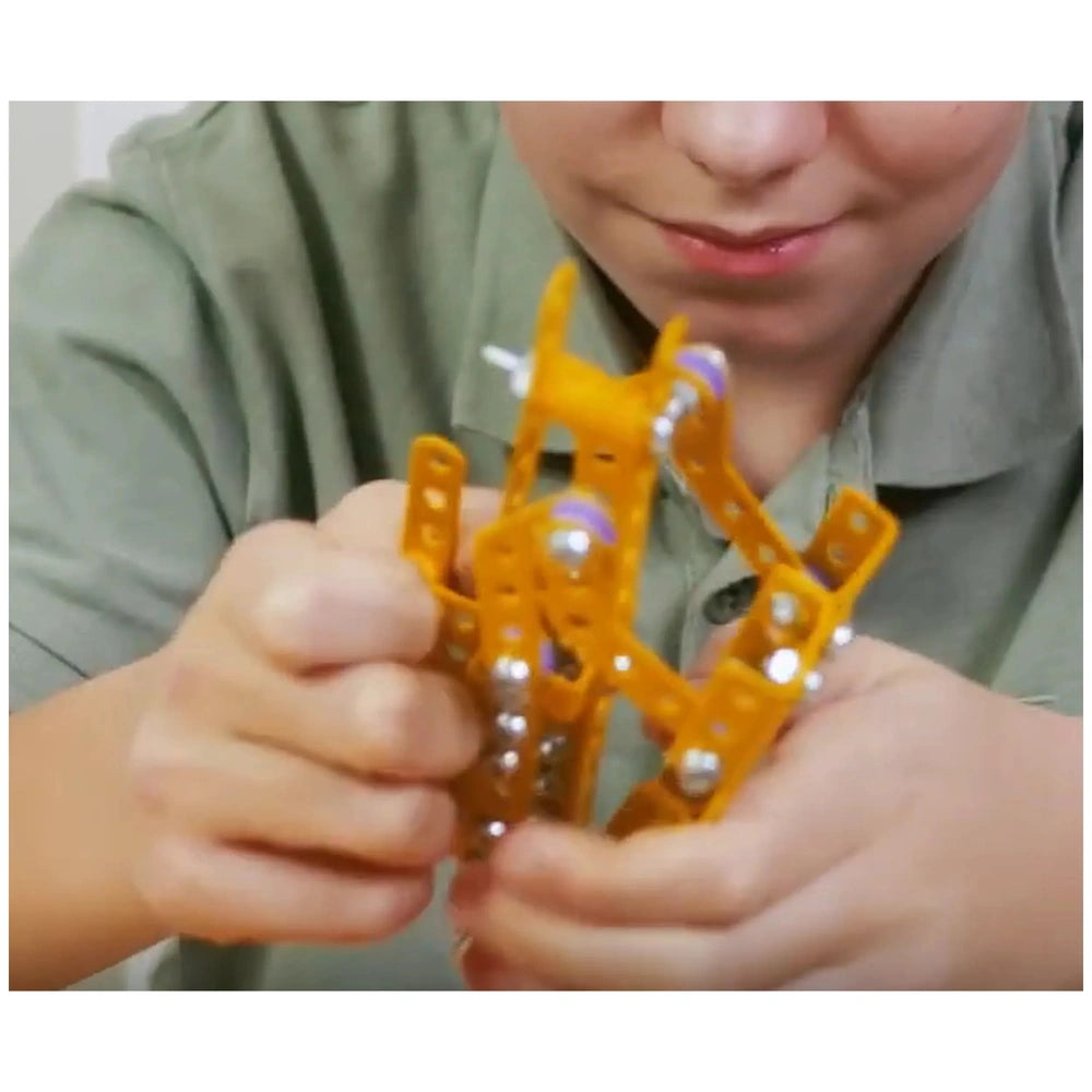 Child assembling yellow and purple parts of Alexander Constructor Ruspa set, enhancing creativity and manual skills.
