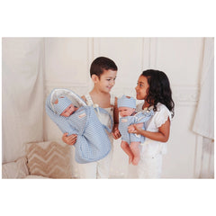 ASI Dolls baby carrier for dolls displayed with a family in a soft, pastel indoor environment, highlighting playtime joy.