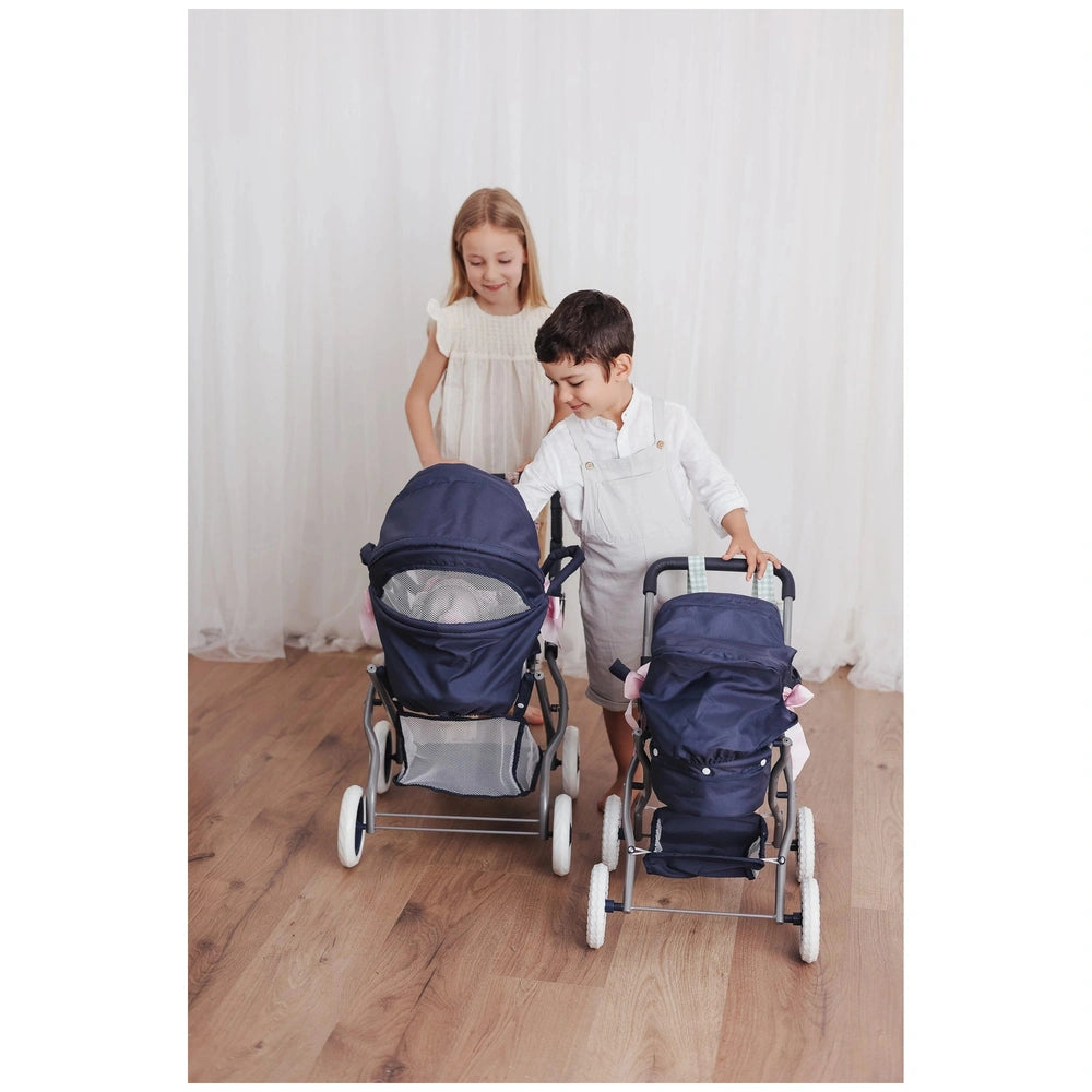 Two children play with ASI Dolls Cloe Small Car Hood Blue strollers indoors.