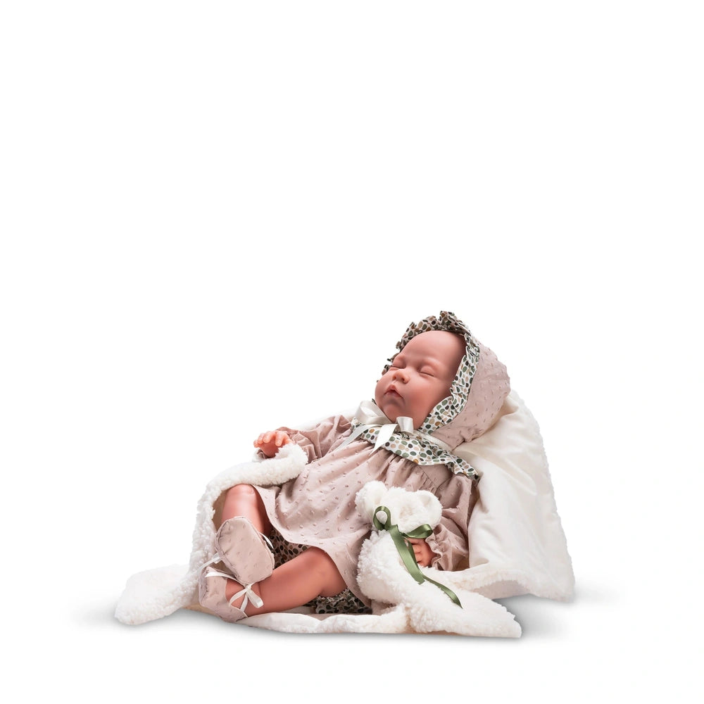Reborn type doll Gisela, 46 cm, in pink outfit and bonnet, lying on white blanket.