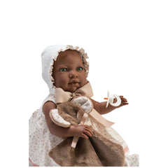 Lara Reborn doll with green eyes, wearing a white bonnet and floral dress, holding a pacifier and blanket.