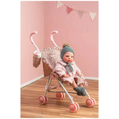 Martina Collection doll stroller with pink wheels, floral fabric, and foam handles, holding a doll in a pink outfit.
