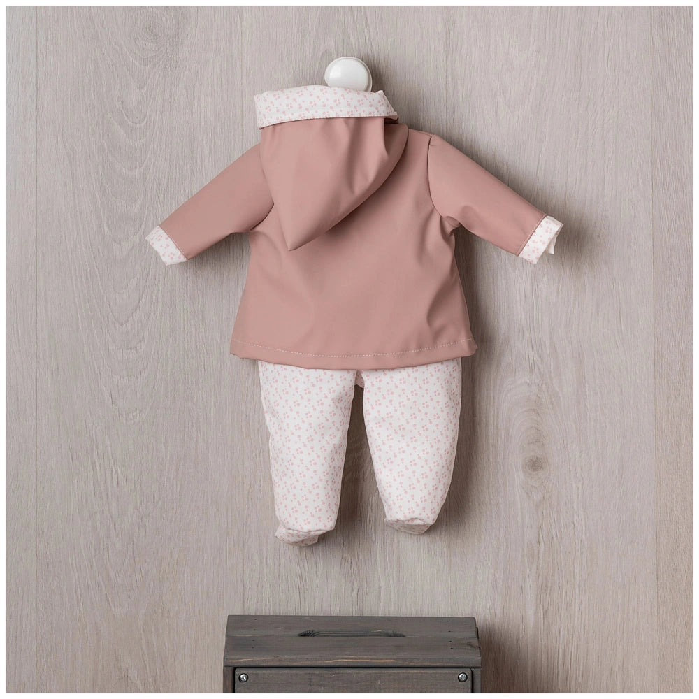 ASI Dolls outfit features a pink hooded jacket with white trim, displayed on a hanger against a neutral wall.