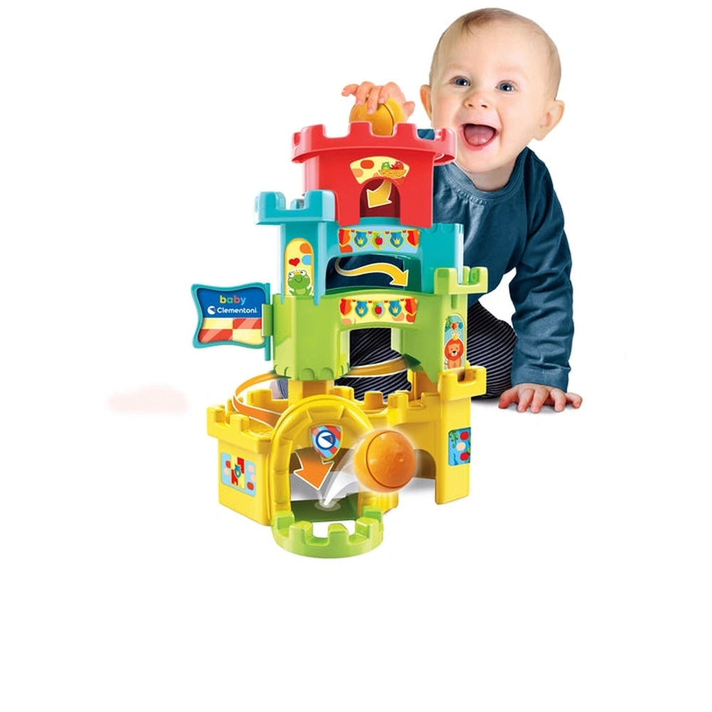 Baby Clementoni Ball Drop Castle is a colorful interactive toy with a castle structure, enjoyed by a smiling child on the flo