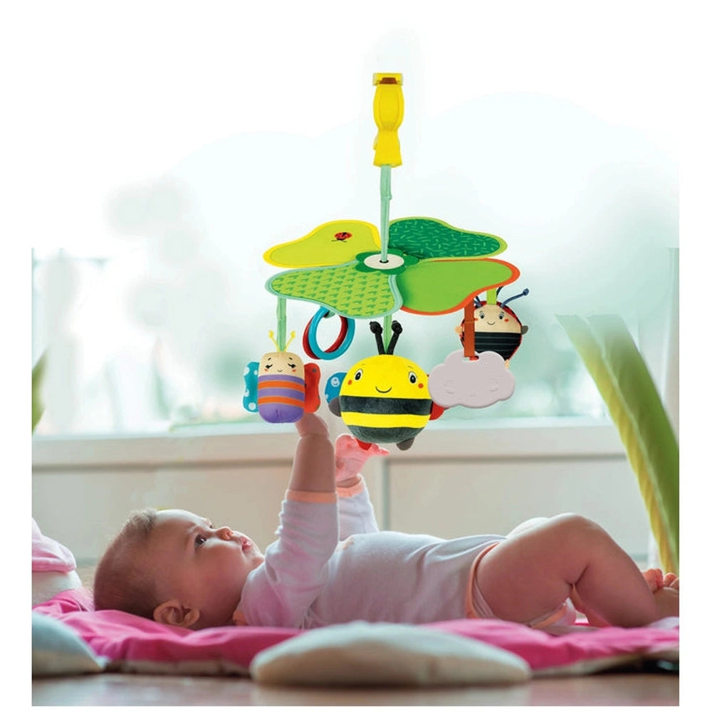 Baby Clementoni Easy-Peasy Travel Mobile features a colorful bee toy hanging above a baby lying on a soft pink mat.
