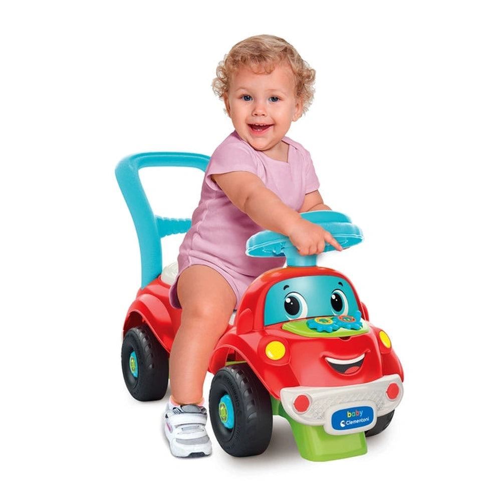 Baby Clementoni Nicolo Go Go riding toy features a smiling toddler in a colorful car with a blue steering wheel and playful d