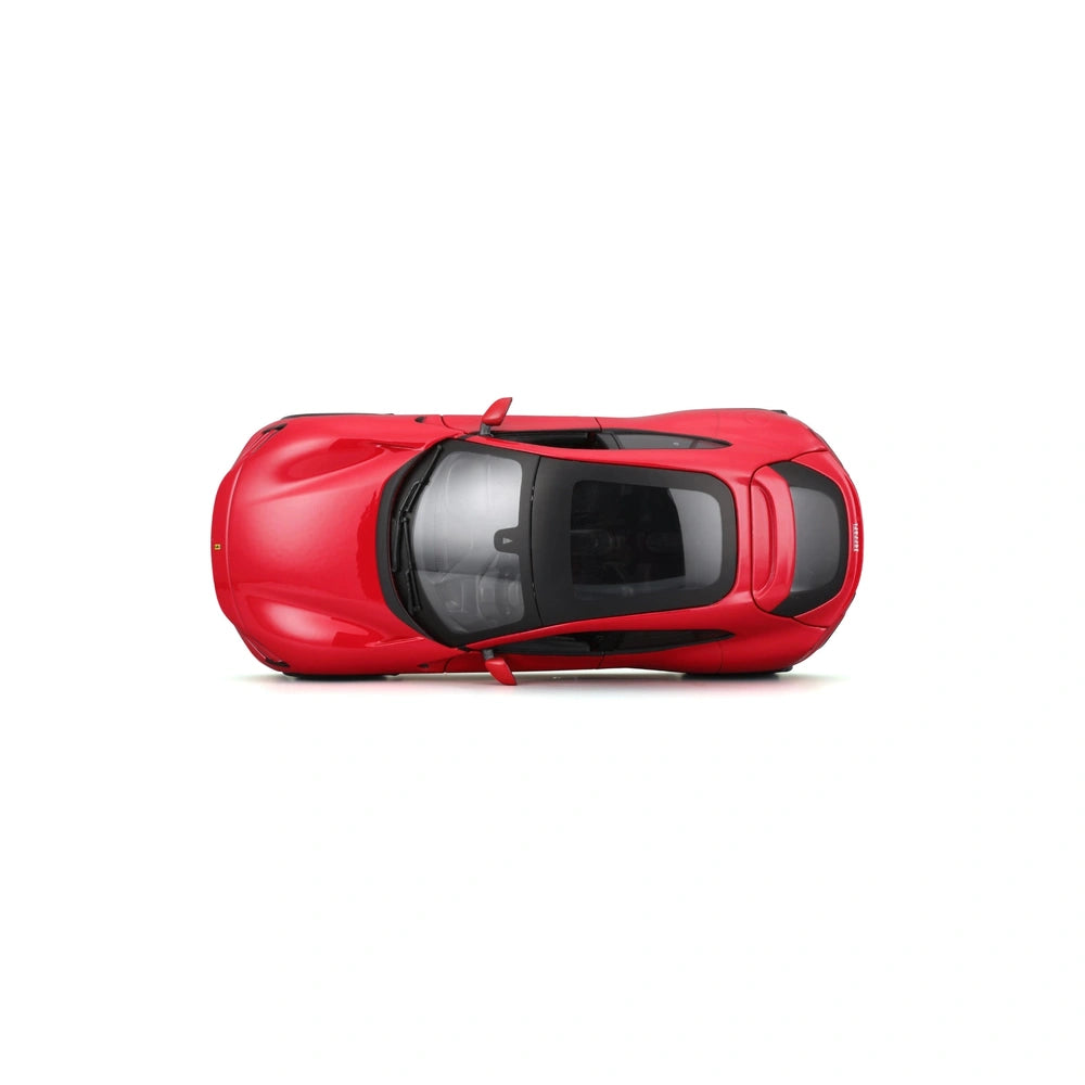Ferrari Purosangue 1:24 die-cast vehicle with shiny red body, black trim, and reflective windows, displayed from the front vi