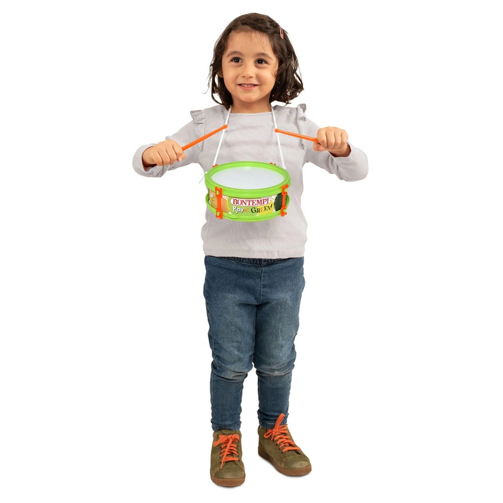Bontempi Marching Drum Play Green held by a smiling girl in a gray sweater and blue jeans, with a green bucket in her hands.