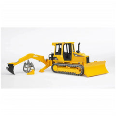 Yellow Bruder toy tractor with rear hydraulic arm and grabber attachment on white background.