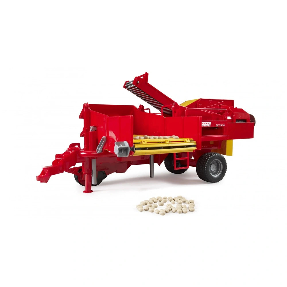Red Bruder Grimme SE75-30 Potato Digger toy with yellow belt, imitation potatoes, and black tread tires on display.