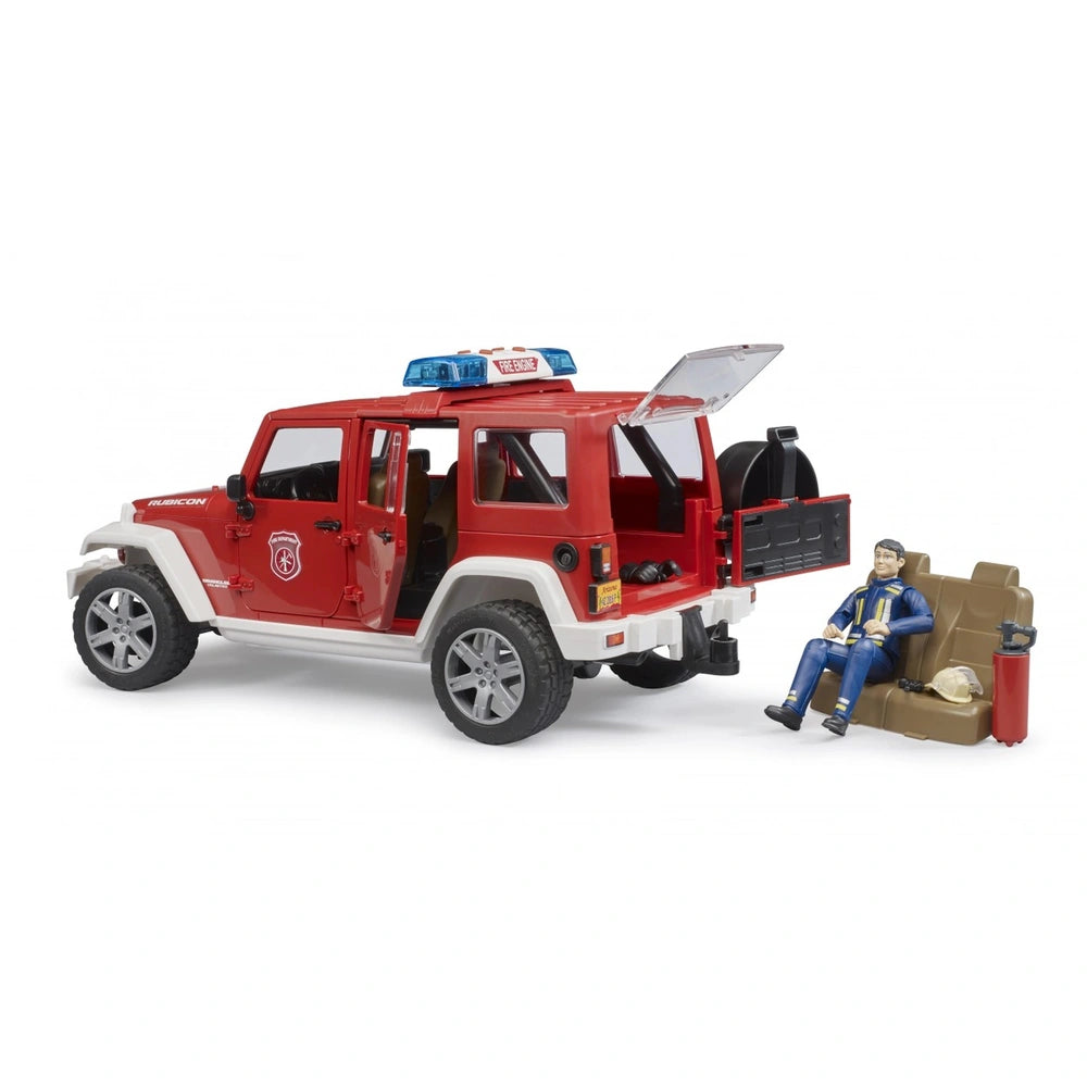 Red toy Jeep Wrangler Rubicon with fire department decals, open doors, firefighter figure, blue hat, and emergency tools.