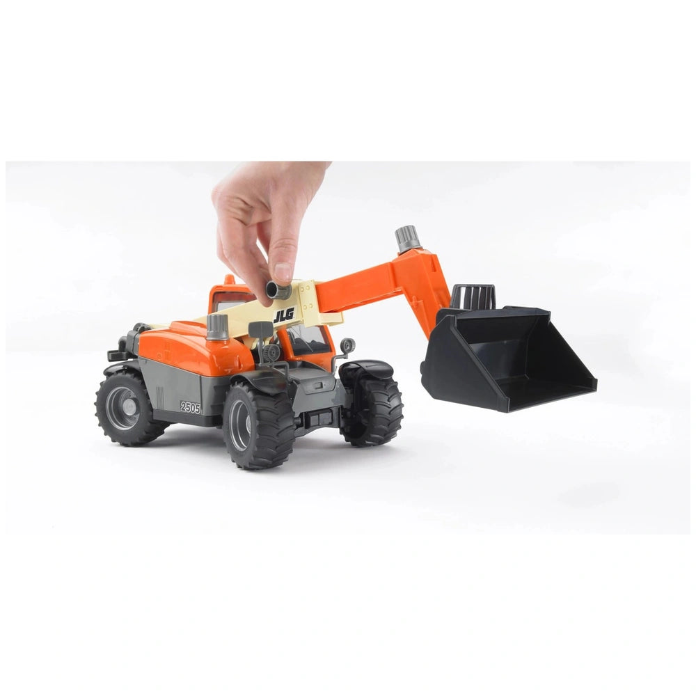 Hand adjusting orange Bruder JLG 2505 Telehandler toy with extendable arm and black bucket attachment.