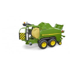 Green John Deere toy baler with yellow wheels, detailed machinery, and visible round hay bale.