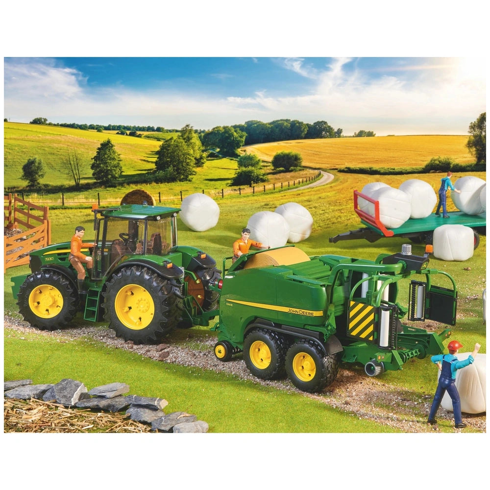 Toy John Deere tractor and baler with figures, rolling hay bales in a picturesque farm setting.
