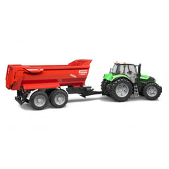 Green tractor with a red Krampe Tandem Halfpipe Tipping Trailer, showing robust wheels and realistic detailing.