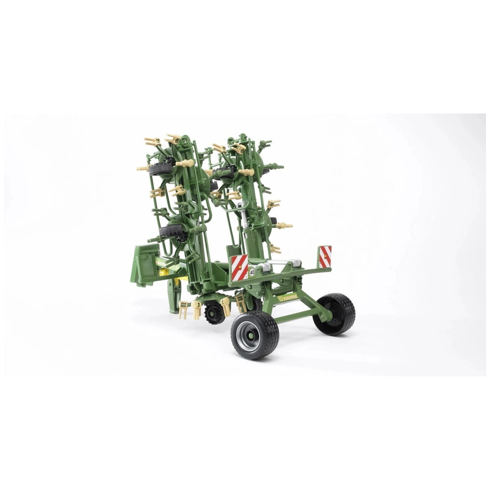 Bruder Krone Trailed Rotary Tedder, green with foldable frame and wheel setup, detailed for farming play.