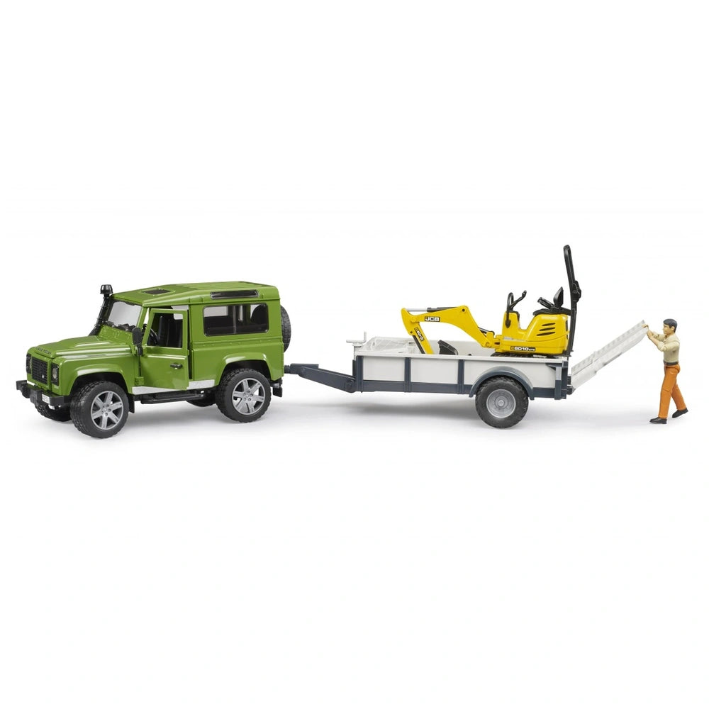 Green Land Rover Defender with a trailer carrying a yellow JCB excavator and a construction worker figure.