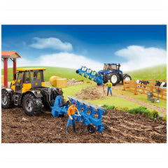 Toy farm scene with two tractors, yellow and blue, in a field with figures and cows in a fenced area.