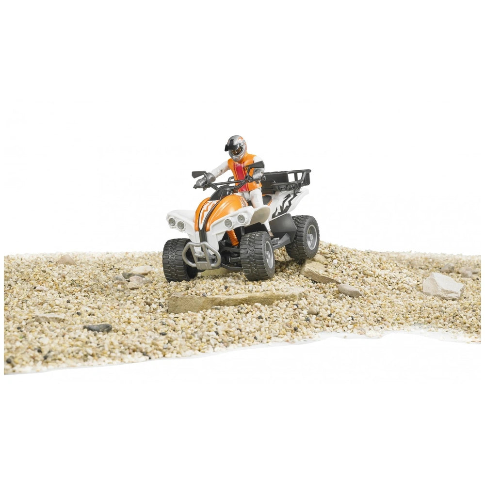 Toy quad bike with a driver on gravel terrain, featuring sleek design and vibrant colors.