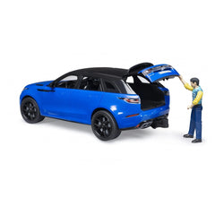Blue Bruder Range Rover Velar toy with open tailgate and figure in casual attire, showcasing realistic details.