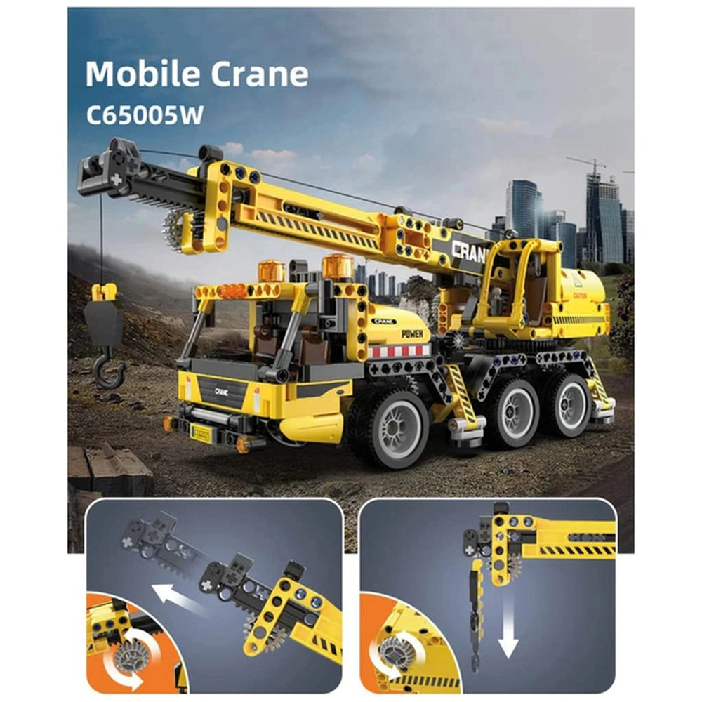 CaDA Mobile Crane Truck in yellow with black and orange accents, set on a dirt street in front of a city skyline and construc