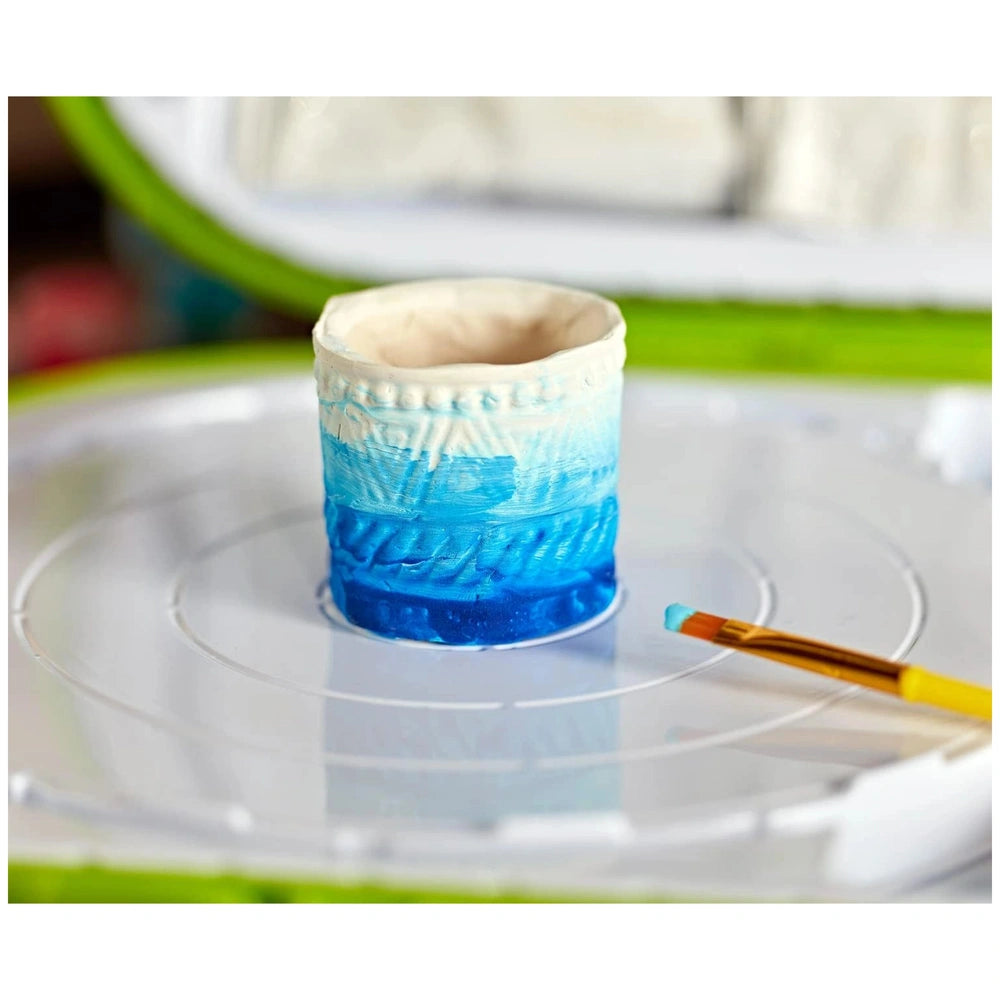 CRAYOLA Clay Sculpting Station features a blue and white patterned cup on a reflective, transparent surface.