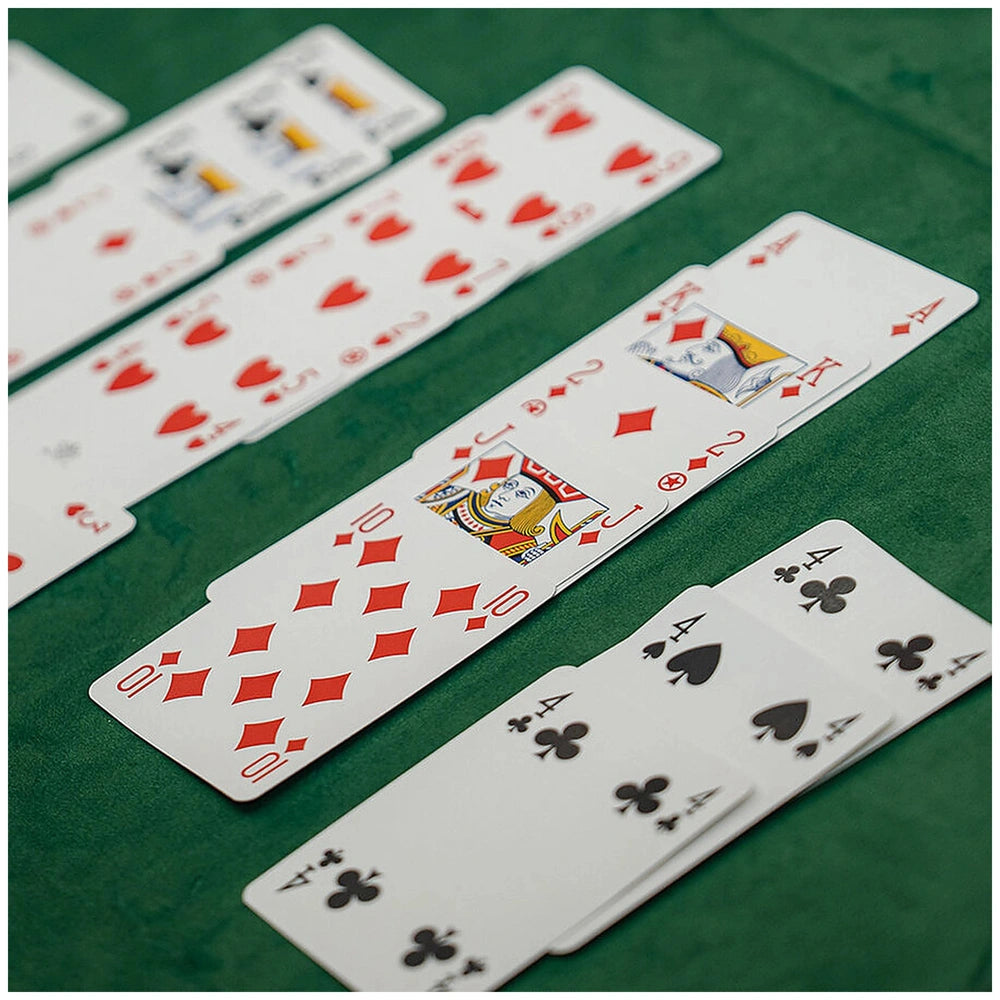 Dal Negro Premium Burraco cards in red and black designs arranged on a green surface, showcasing a smooth cardstock finish.