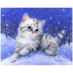 Diamond Dotz arts and crafts kit featuring a white kitten amidst blue background and white snowflakes.