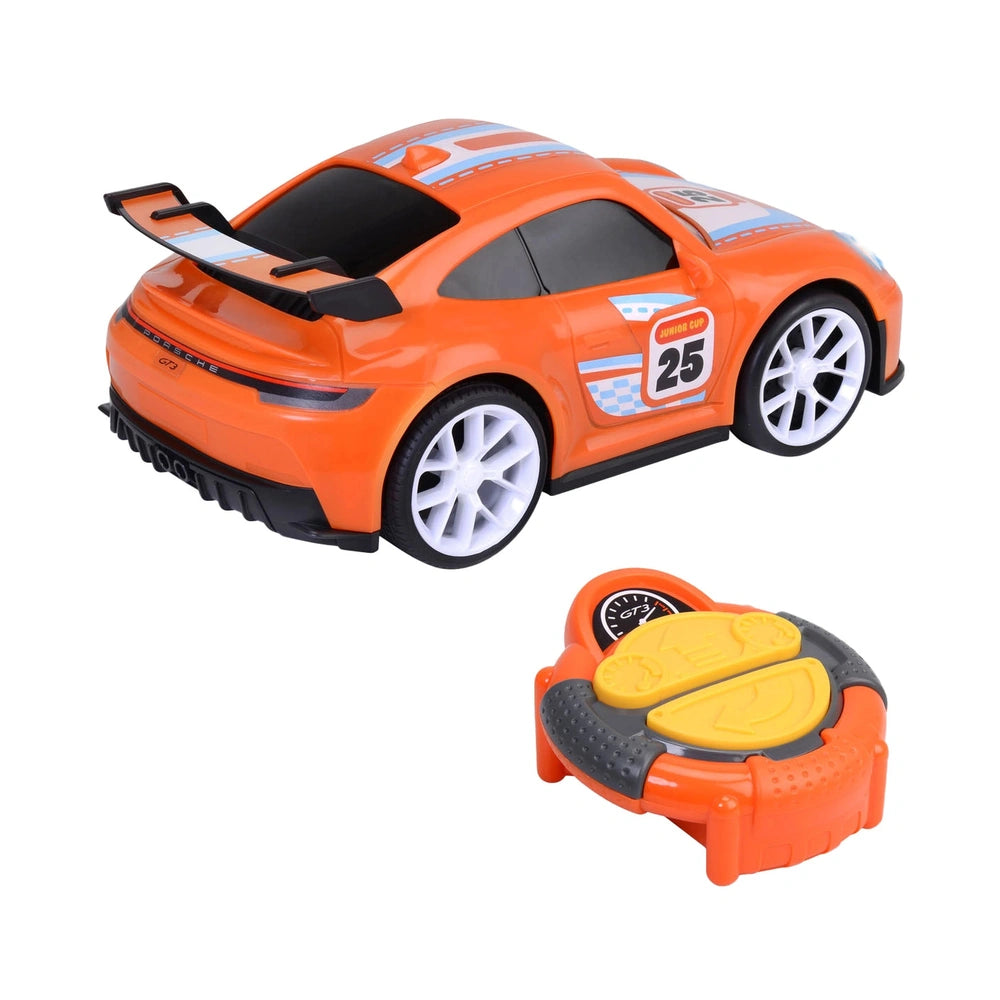 Dickie remote-controlled Porsche 911 GT3 play vehicle in orange with glossy body, white wheels, and yellow seat.