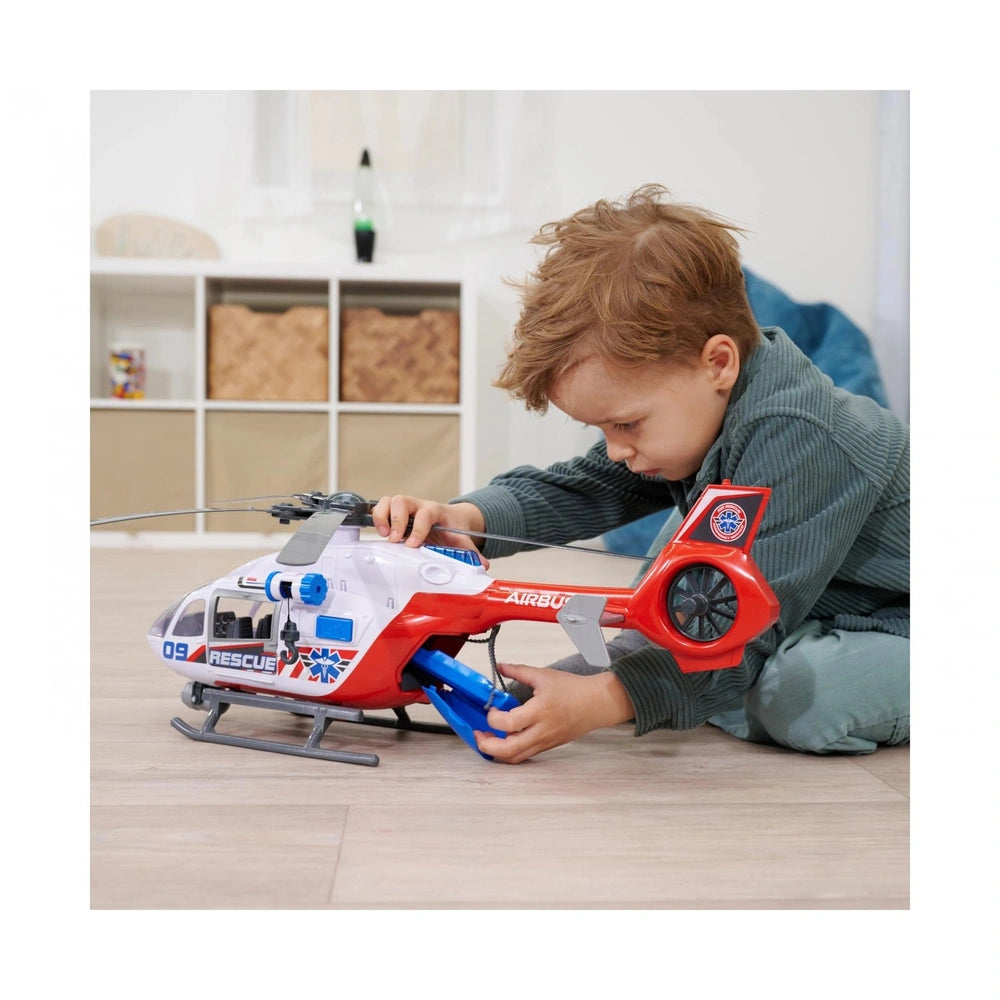 Dickie Giant Helicopter Play Vehicle with a child in a dark green shirt and light green pants, playing on light wood flooring