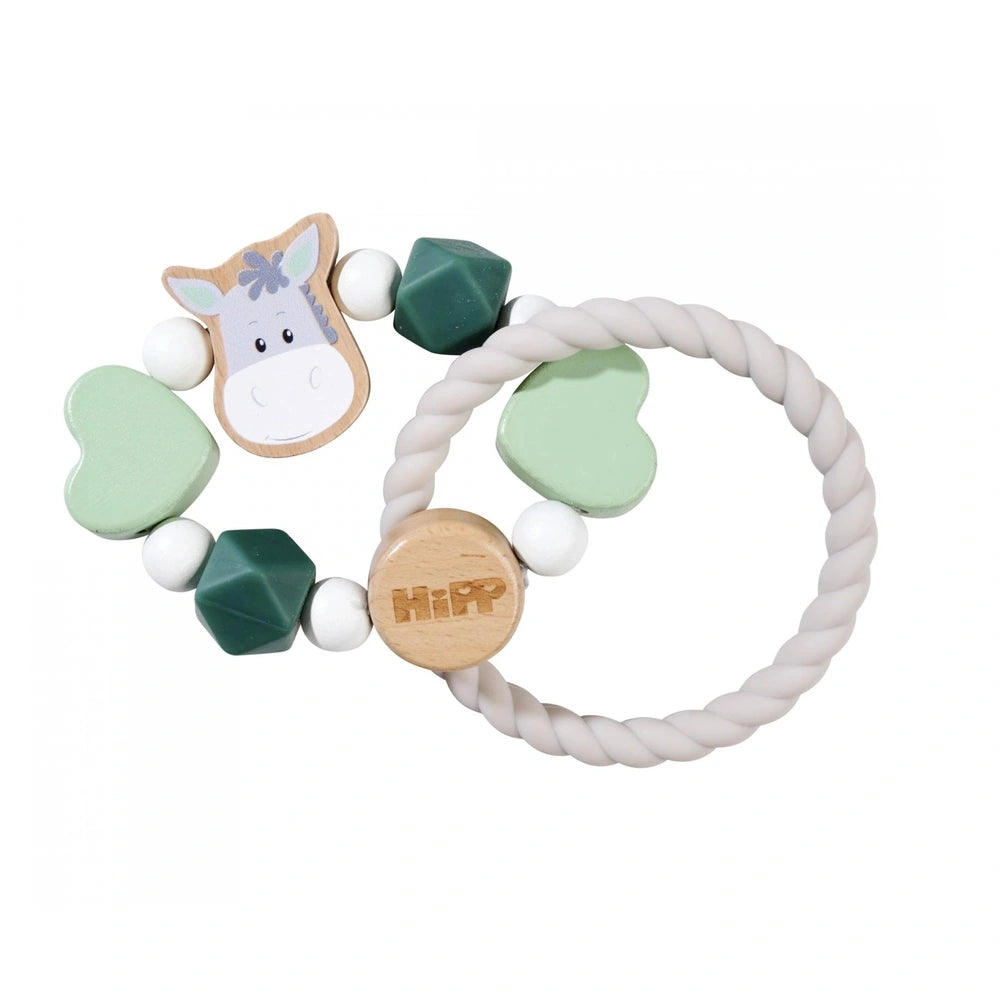 Eichhorn Baby HiPP Grapper features a colorful bracelet, a cartoon horse figurine, and a wooden keychain with HIP engraved.
