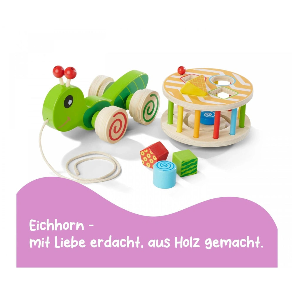 Eichhorn Color Pull-along Stacking Animal toy features vibrant green, yellow, and red components made of plastic and wood.