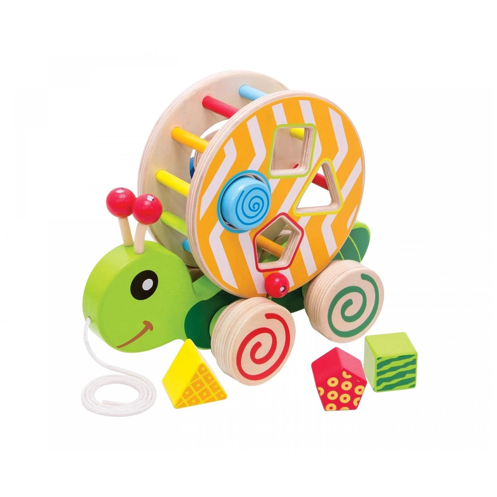 Colorful pull-along turtle toy with a spiral shell, smiling face, and smaller house and car components on a white background.