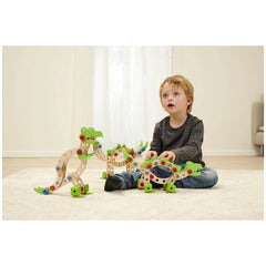 Eichhorn Constructor Dinosaur construction set with colorful pieces, played with by a child on wooden flooring.