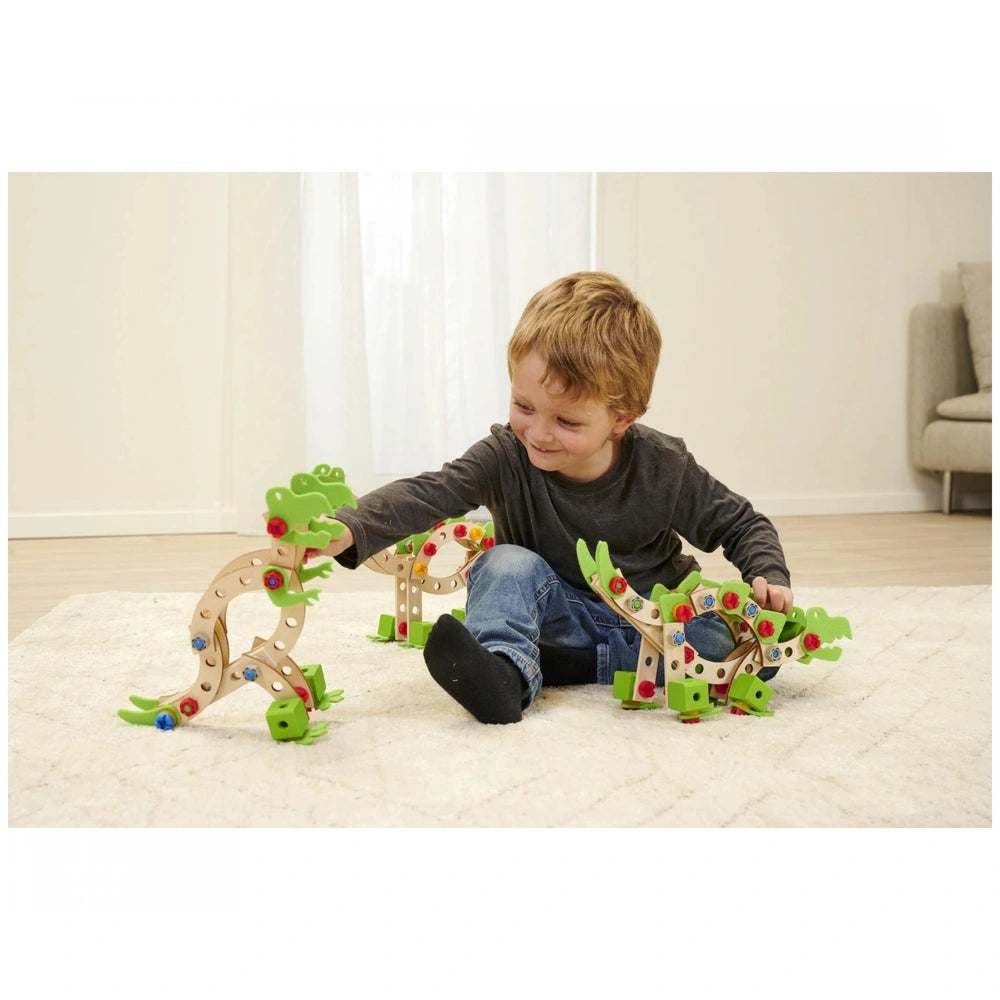 Eichhorn Constructor Dinosaur construction set with green and brown toy, red and blue accents, on a carpeted floor with a chi