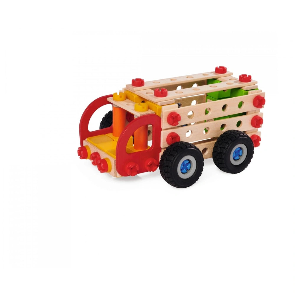 Wooden toy truck with a red cab and yellow flatbed trailer, featuring black wheels and silver hubcaps on a white background.