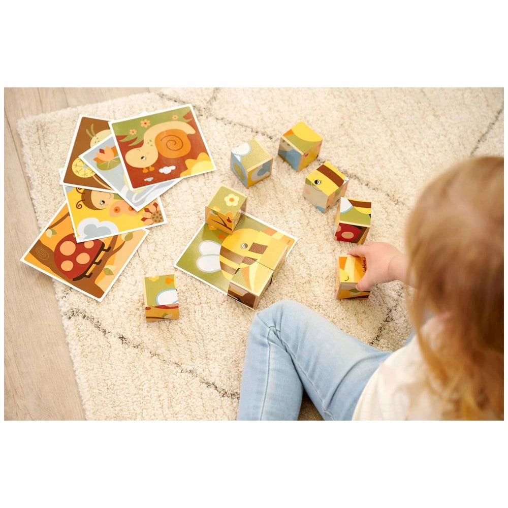 Eichhorn cubes and puzzles are scattered around a child playing on a neutral-colored carpet, featuring vibrant colors and sha